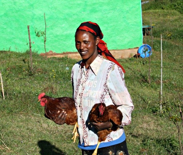 Ayelech holding chickens.